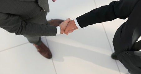 Two business men shaking hands  in the office