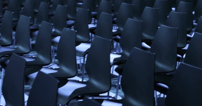 large Empty conference hall with rows of seats for spectators and audience.