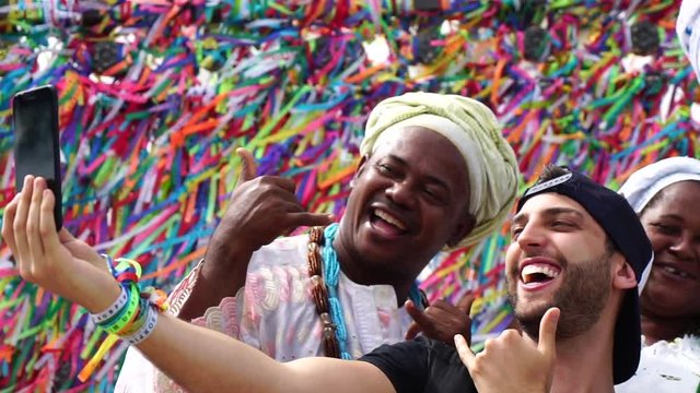 Tourist recording with Candomble group at Bonfim Church in Salvador, Bahia, Brazil