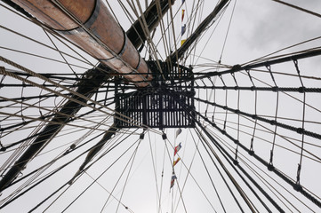 Rigging leading up the mast of a tall ship to the crows nest.