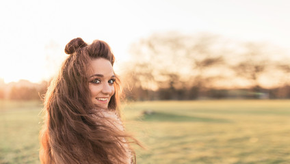 Close up portrait of a beautiful woman smiling with sunset