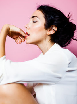 Side profile of woman biting her nails
