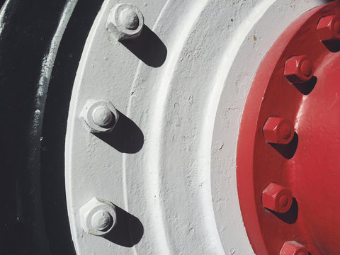 Bolts attached to large industrial wheel, close up