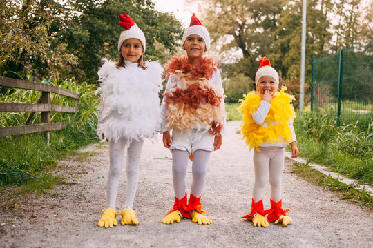 Kids hanging around with chicken, rooster anc chick costume