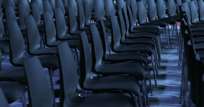 large Empty conference hall with rows of seats for spectators and audience.