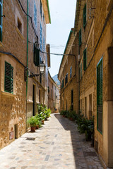 Fototapeta na wymiar Cobbled stone narrow street at Soller village, Majorca, Spain