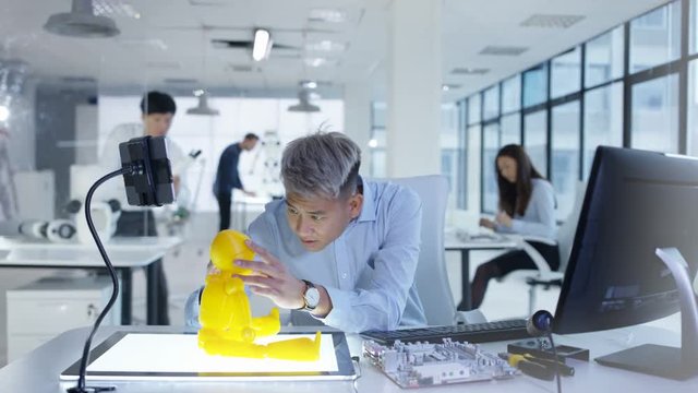  Electronics engineers in the lab working on a prototype for automated robot