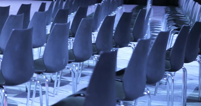 large Empty conference hall with rows of seats for spectators and audience.