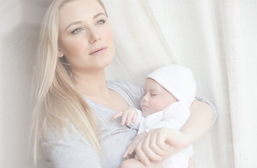 Obraz na płótnie Canvas Cute mother with newborn baby