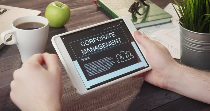 Reading corporate management information using tablet computer at desk