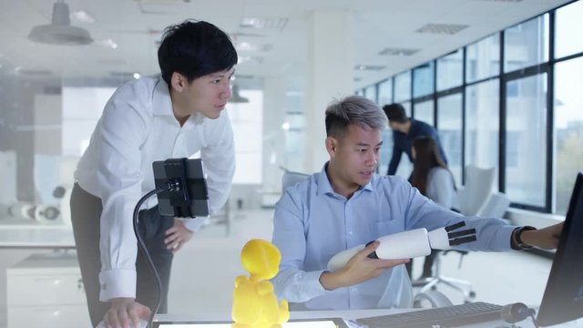  Electronics engineers in the lab working on a prototype for automated robot