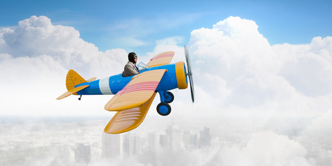 Naklejka na ściany i meble man flying in retro plane. Mixed media
