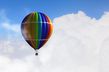 Aerostat floating in day sky. Mixed media