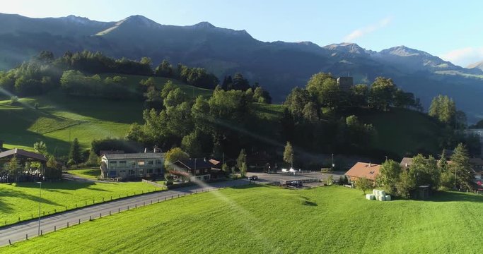 Amazing scenic aerial view of countryside area and village in swiss mountain foothill. The incredible peaceful beauty of swiss alpine landscape. Vacation, destination and travel concept.
