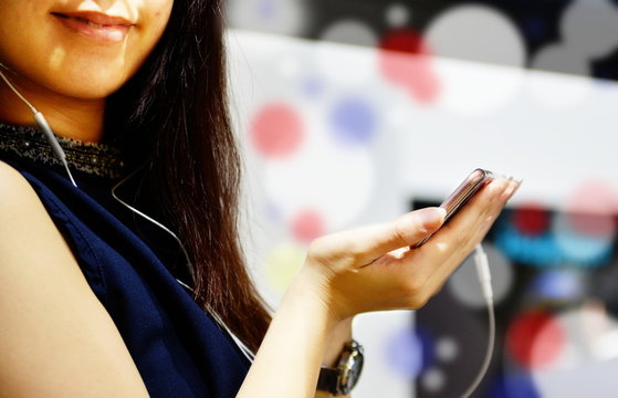 Young lady listening music video with headphones