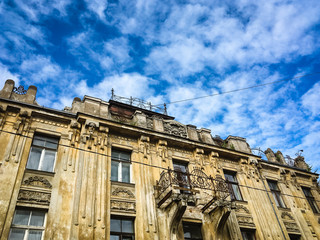 Old building on blue sky background and white clouds