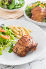 grilled chicken steak with french fries and vegetable salad