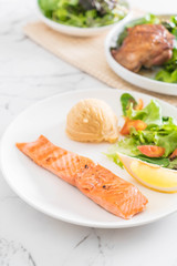 grilled salmon steak with mash potato and vegetable