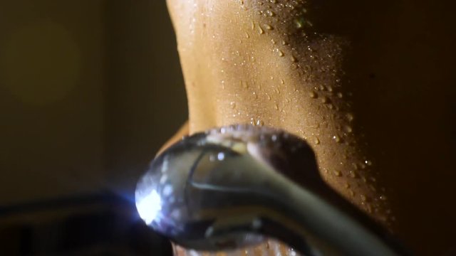 woman taking a shower in super slow motion. young girl under shower playing and enjoy water .