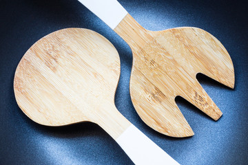 Wooden spatula on coating pan background