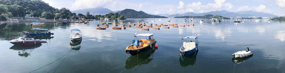 Fototapeta na wymiar Panorama photography of mountain, cloudscape, boats, sailboat and yacht on lake