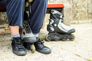 Man putting on roller skates outdoor.