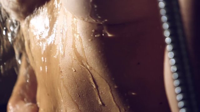 woman taking a shower in super slow motion. young girl under shower playing and enjoy water .