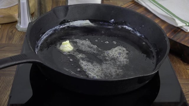 Melting butter in a cast iron pan

