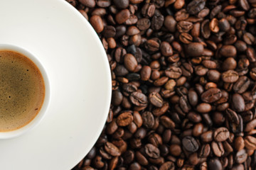 cup of coffee espresso on coffee beans backgroun. close up