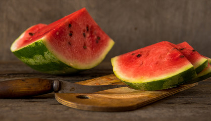 Watermelon slices on the woodan table. Fresh red watermelon. Rustical style.