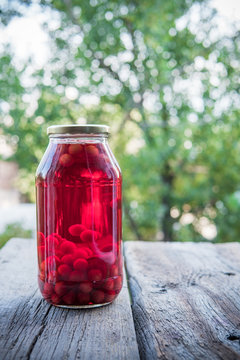 Cherry compote in the big glass jar. Homemade preserved cherries