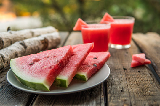 Watermelon coctail on a wooden board in a garden. Selective focus