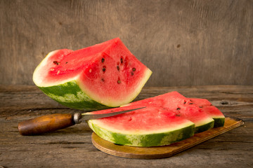 Watermelon slices on the woodan table. Fresh red watermelon. Rustical style.