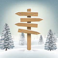 christmas wood direction board sign in snow forest