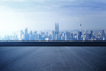 Highway overpass with modern city skyline background