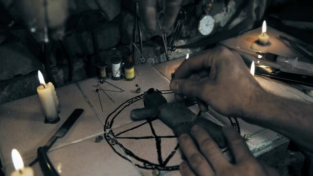 the mage conducts a ritual with the voodoo doll