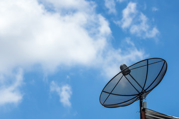 Satellite dish cable on roof with blue sky and some cloud.