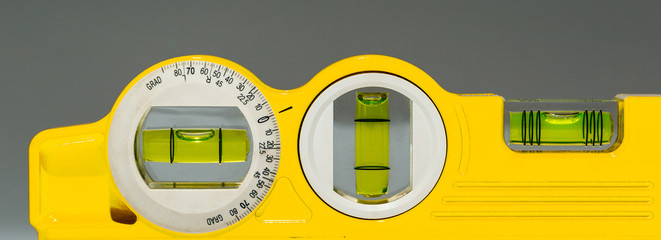 Yellow bubble level isolated on grey background