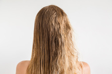 Woman's wet blonde hair after shower on the gray background. Before and after hair brushing with comb. Cares about a healthy and clean hair. Beauty salon concept. © fotoduets