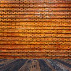Room with red brick clay stone wall with wooden plank floor for product display.