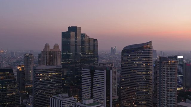Timelapse day to night cityscape view of modern building in business area town at Bangkok in Thailand