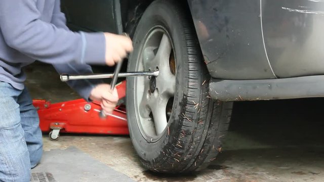 replacing an old tire on car