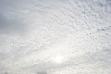 Obraz premium Clouds in a blue sky in sunlight at fall