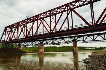 Fototapeta na wymiar The bridge through the river