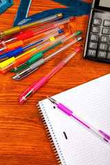 Frame of school supplies on the wooden table, top view