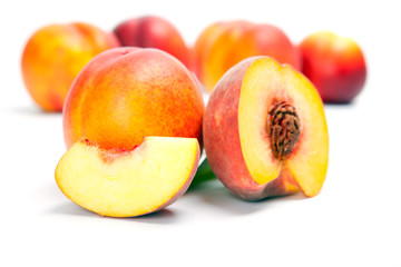 Fototapeta na wymiar fresh whole peaches with cut, isolated on white background