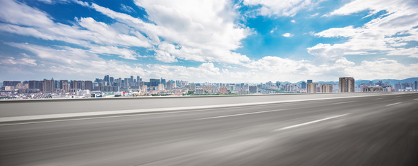 empty asphalt road and cityscape of modern city © zhu difeng