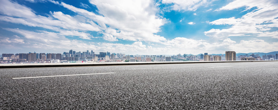 empty asphalt road and cityscape of modern city