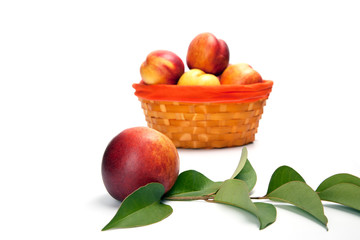 fresh peach fruits with green leaves isolated on white background