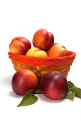 Fresh fruit nectarines in the basket, on white background